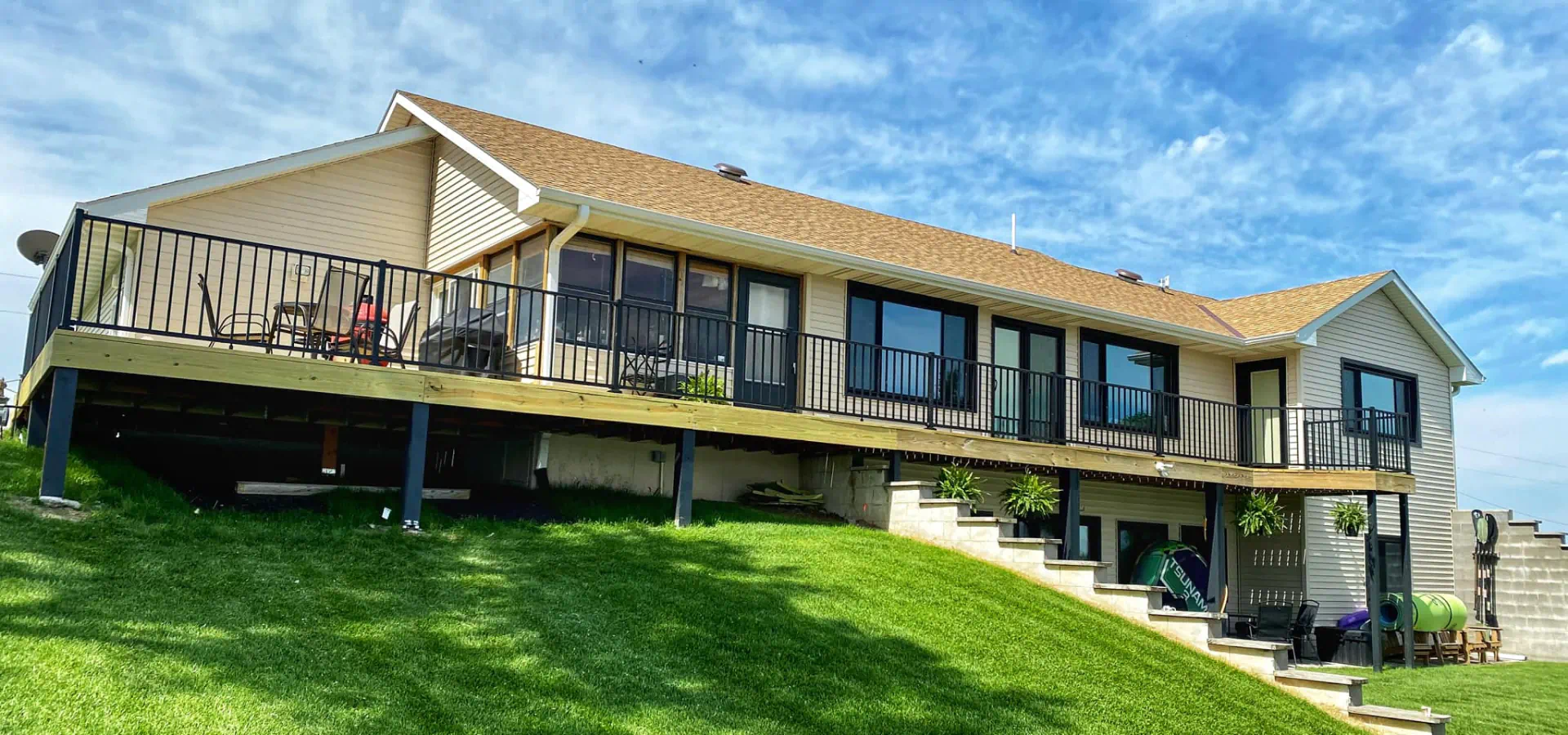 huge residential house with clean roof and elevated wooden deck
